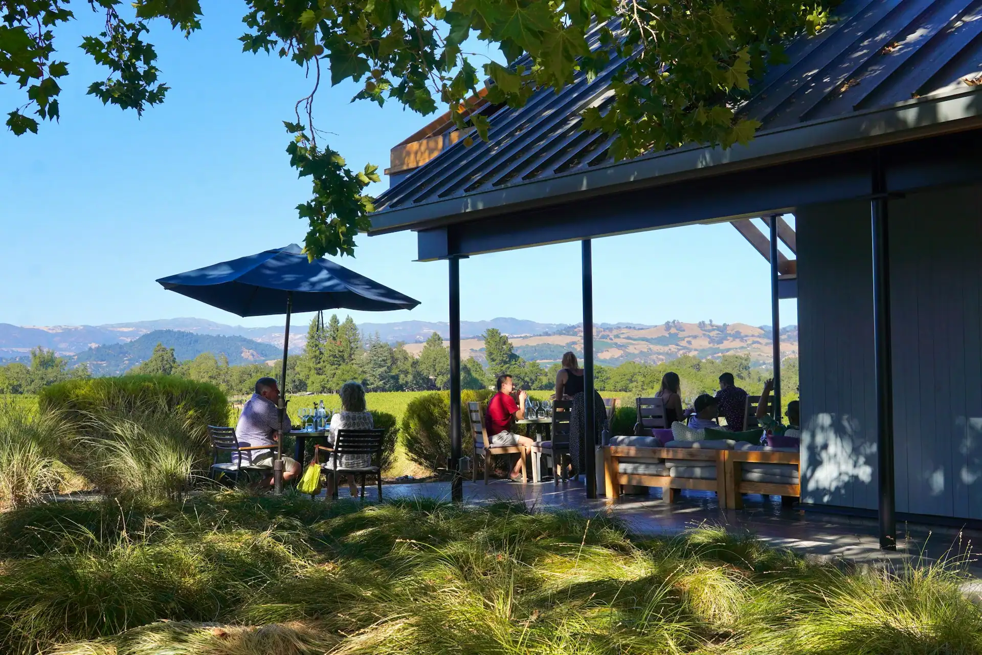 People at Table Under Umbrella